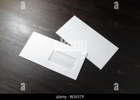 Two blank envelopes on wood table background. Front and back side. Template for branding identity. Stock Photo
