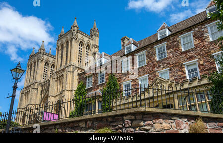 Bristol, UK - June 30th 2019: A view of the towers of the magnificent Bristol Cathedral alongside the beautiful building that houses the Bristol Cathe Stock Photo