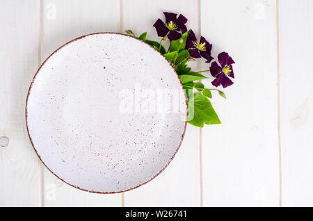 Plate with violet flowers, mock up for menu.  Stock Photo