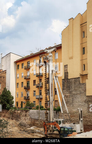 Auger drilling machine near house. Industrial machinery on building Stock Photo