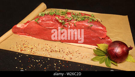Joint of rump steak ready to slice on brown grease proof paper Stock Photo