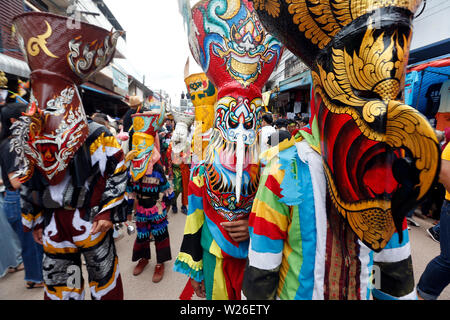 Thai people wear masks representing the spirits of the dead springing ...