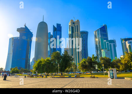 Doha, Qatar - February 20, 2019: Woqod Tower, Alfardan Towers and Doha Tower, iconic glassed high rises in West Bay from Sheraton Park along corniche Stock Photo