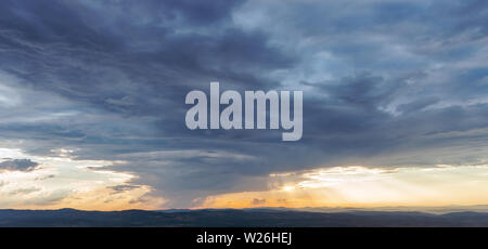 Rays of light shining throug dark clouds Stock Photo