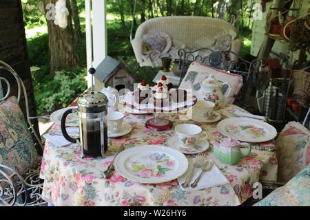 FRENCH PRESS and CHOCOLATE CUPCAKES ON THE PORCH Stock Photo