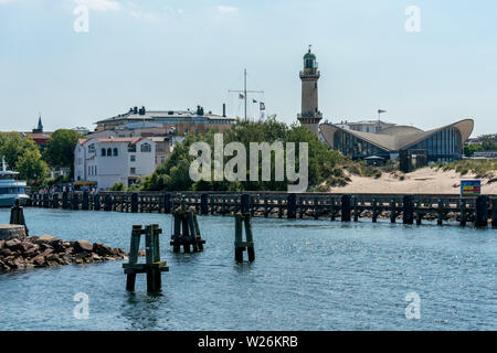 view on Warnemuende lighthouse, harbour and Teepott from a ship with water in the foreground Stock Photo