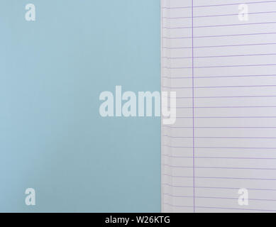 Open blank  notebook with lined papers on light blue background with copy space. Stock Photo