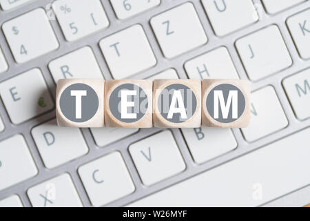 cubes with letters forming the word TEAM on a keyboard Stock Photo