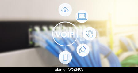 Network Line Cables in data center room background with virtual reality icon diagram,Row of blue UTP network cables that are connected to a switch Stock Photo