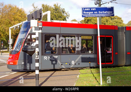 Street sign naming Reagan and Gorbachov way/lane/avenue, in the Hague, Den Haag. The tram is an Avenio, manufactured by Seimens Stock Photo