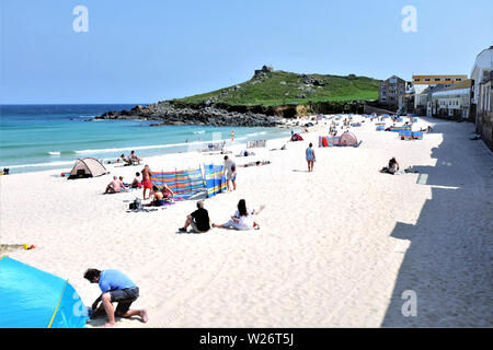 St. Ives, Cornwall, UK. June 27, 2019. Holidaymakers enjoying the soft white sands of Porthmeor beach at St. Ives in Cornwall, UK. Stock Photo