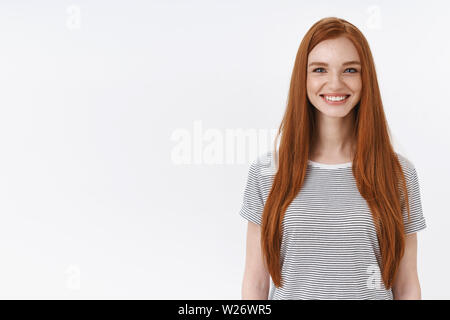 Charming friendly pleasant redhead girl university student smiling happily camera look energized participate dance class learning new hobby standing w Stock Photo