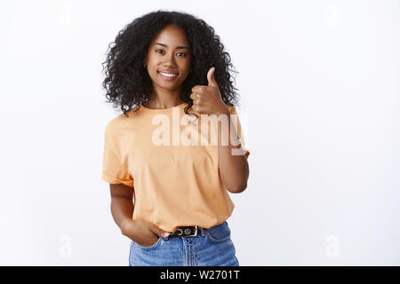 Nice job, not bad. Portrait proud satisfied good-looking female coworker check out excellent work you done show thumb-up pleased smiling delighted, gi Stock Photo