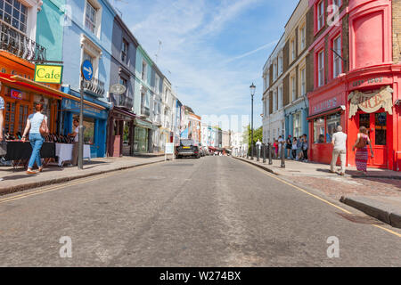 LONDON ENGLAND - JULY 15 2013;  People on street outside typically English old buildings and Alice's Antiques red fronted shop on Portobello Road. Stock Photo