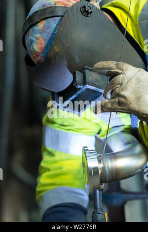 welder fabricates steel structures using semi-automatic welding in shielding gases Stock Photo