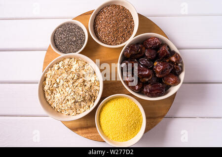 Top view the set of Superfoods in Bowls over white wooden Background. Stock Photo
