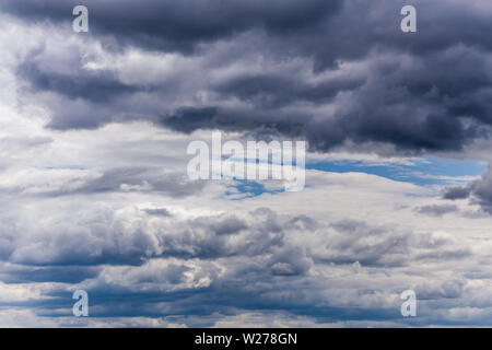 gray incoming near storm clouds at daylight backdrop Stock Photo