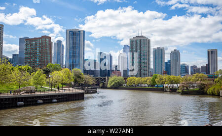 Chicago cityscape, spring day. Chicago city waterfront high rise buildings on the river canal, blue sky background
