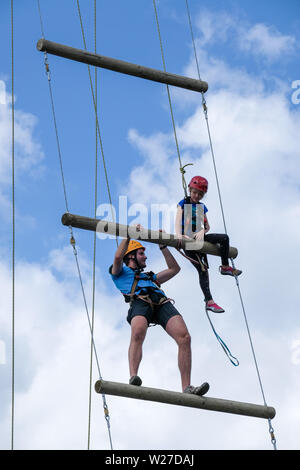 Dortmund/Germany, 19th June 2019. At the Protestant Church Congress 2019 in Dortmund, a girl (10 years) climbs up to a height of 17 meters on a ladder to heaven. A helper assists with ropes to reach the next level. Stock Photo