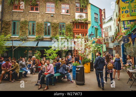 London, UK - January, 2019. Tourists and locals in Neal's Yard, a small alley in London's Covent Garden  which opens into a courtyard. Stock Photo