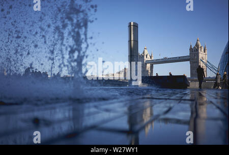 London, UK - February, 2019. View of the Tower Bridge from the South Bank with a water fountain on the foreground.