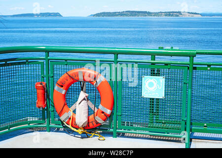 Mukilteo WA - May 18 2019. A life saving belt by the railing on a ferry boat. Stock Photo