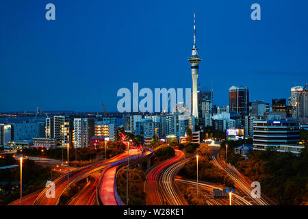 Motorways, Lightpath cycleway, and Sky Tower at dusk, Auckland, North Island, New Zealand Stock Photo