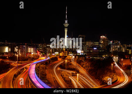 Motorways, Lightpath cycleway, and Sky Tower at night, Auckland, North Island, New Zealand Stock Photo