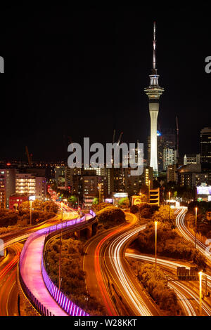 Motorways, Lightpath cycleway, and Sky Tower at night, Auckland, North Island, New Zealand Stock Photo