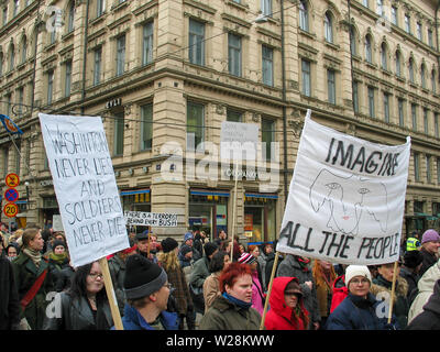 Helsinki, Finland - March 22, 2003: Anti-war protesters march through downtown Helsinki to protest the impending United States invasion of Iraq. Stock Photo