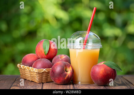 peach juice in plastic cup Stock Photo