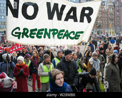 Helsinki, Finland - March 22, 2003: Anti-war protesters march through downtown Helsinki to protest the impending United States invasion of Iraq. Stock Photo