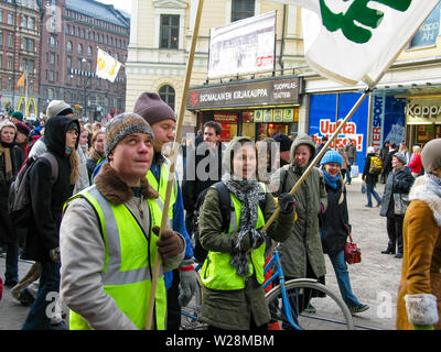 Helsinki, Finland - March 22, 2003: Anti-war protesters march through downtown Helsinki to protest the impending United States invasion of Iraq. Stock Photo