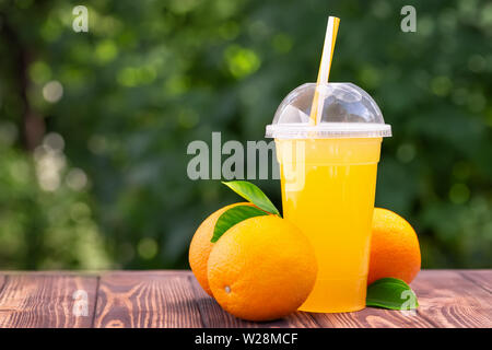 orange juice in plastic cup Stock Photo
