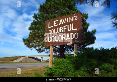 Large Leaving Colorful Colorado Wooden Roadside Highway Sign on a Sunny Day Stock Photo