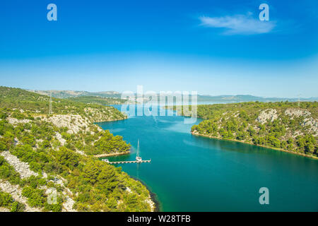 Scenic view of the Krka river in a beautiful summer day in Croatia, sailing boats passing through the canyon Stock Photo