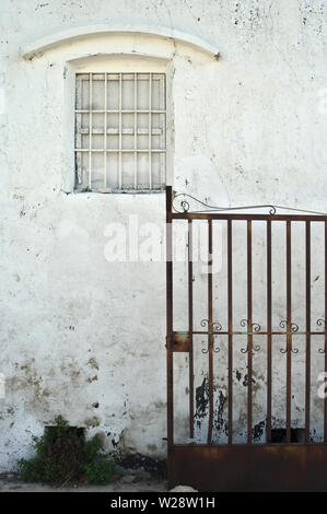 old white wall with window with deteriorated paint Stock Photo