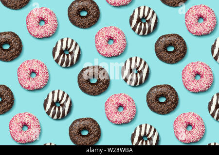 Decorative donuts seamless patterm on blue background Stock Photo