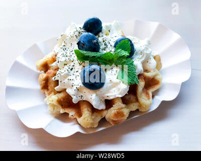 Viennese waffles with cream and blueberries. Studio Photo Stock Photo