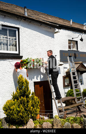 UK, Cumbria, Hawkshead, The Square, dressing the Kings Arms Hotel with floral planters in early summer Stock Photo