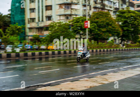 Mumbai, India - June 30, 2019 : Unidentified kid driving motorbike with Indian flag on streets of Marine drive Stock Photo