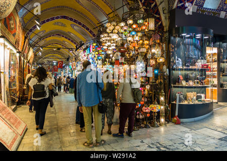 Tourists purchasing lamps and other handicraft souvenirs at Grand Bazaar. Istanbul, Turkey, October 2018 Stock Photo