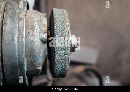 Old Dusty Bench Grinder in a Home Garage.  Vintage Work Tools Concept. Stock Photo