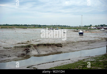 Boats left high & dry on the mud at low tide on the Thames Estuary, Old Leigh, Leigh-on-Sea, Essex, England, United Kingdom Stock Photo