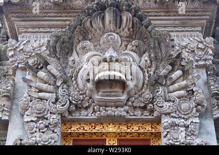 Close up picture of a typical Balinese stone mask sculpture that can be found at the most temples around Bali. This one is located at the Saraswati te Stock Photo