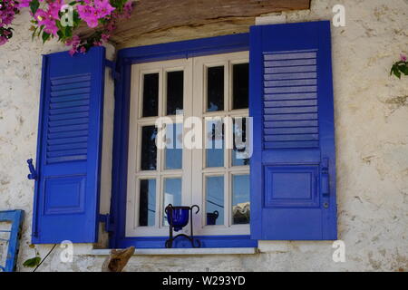 Afionis village house with a beautiful louvered shuttered wooden and blue coloured window Stock Photo
