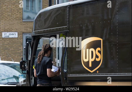 A United Parcel Service (UPS) delivery van and driver on the streets of London, England, U.K. Stock Photo