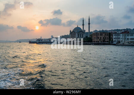 Scenic view of Ortakoy Mosque at sunset from a ferry boat sailing the Bosphorus strait, Istanbul, Turkey Stock Photo