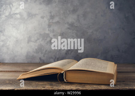 Open book on the table against the wall Stock Photo