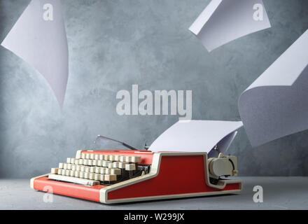 Typewriter on the table with paper sheets Stock Photo